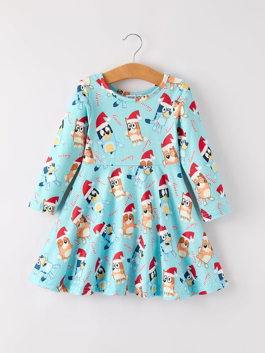 Children's dress with Christmas-themed dog print on a hanger against a white background