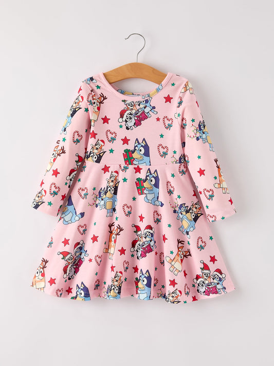 Pink dress with cartoon character print on a hanger against a white background
