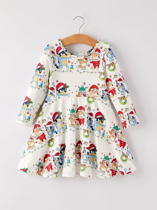 Children's dress with Christmas-themed print on a hanger against a white background