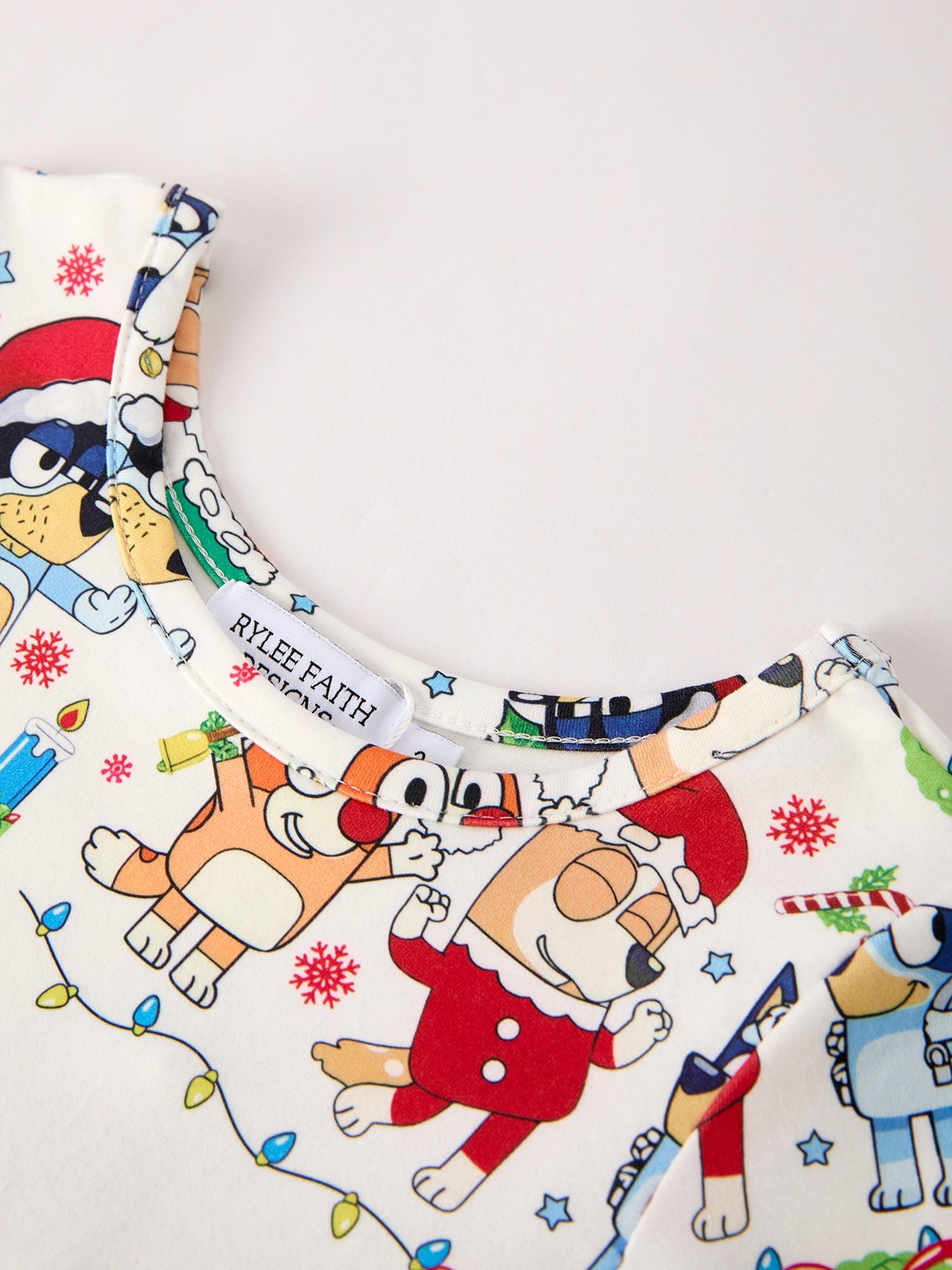 Children's clothing with cartoon dog design and festive elements on a white background