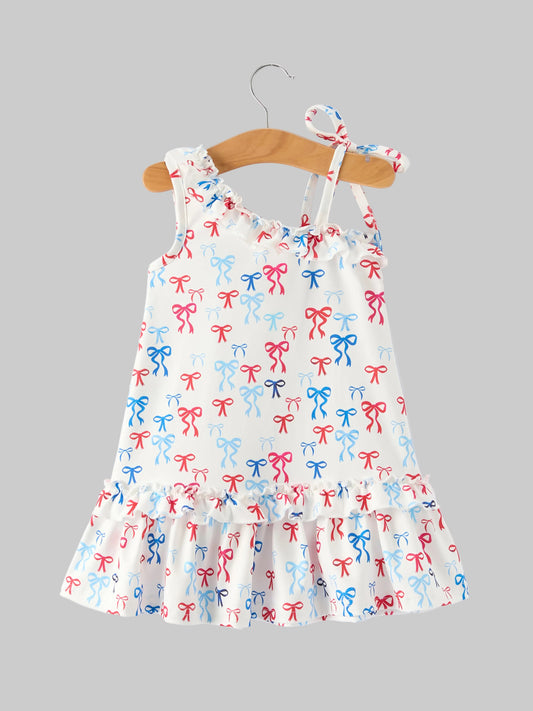 Children's dress with bow pattern on a hanger against a white background