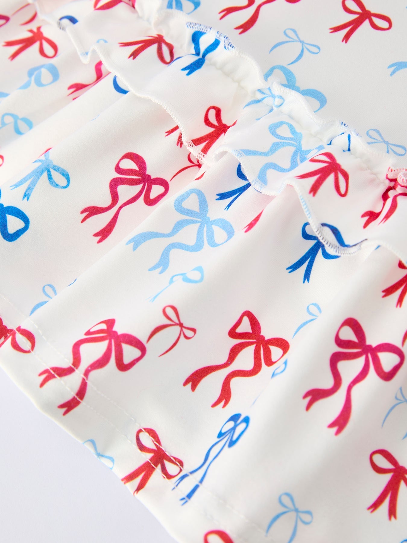 Fabric with red and blue bow pattern on a white background