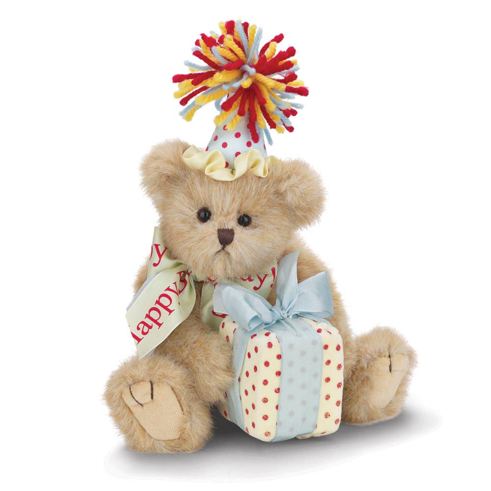 Teddy bear with a party hat and gift box on a white background
