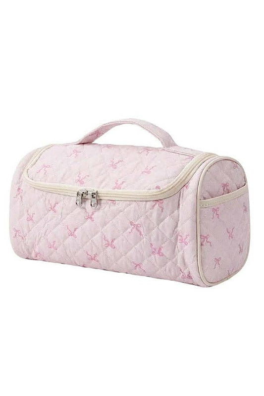 Pink quilted toiletry bag with butterfly pattern on a white background