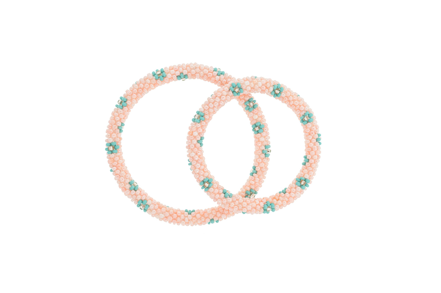 Set of pink hair ties with green floral designs on a white background