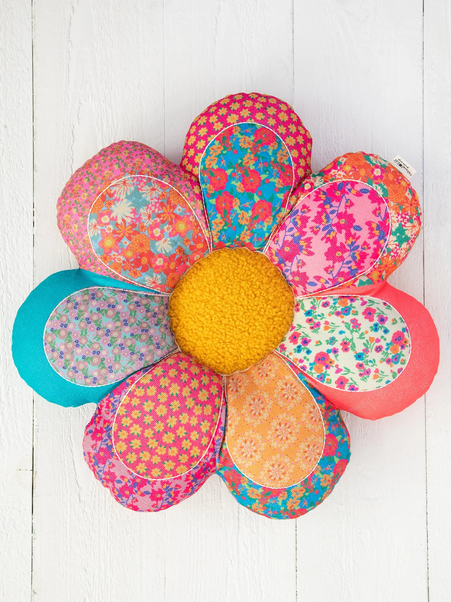 Colorful flower-shaped craft project on a white background