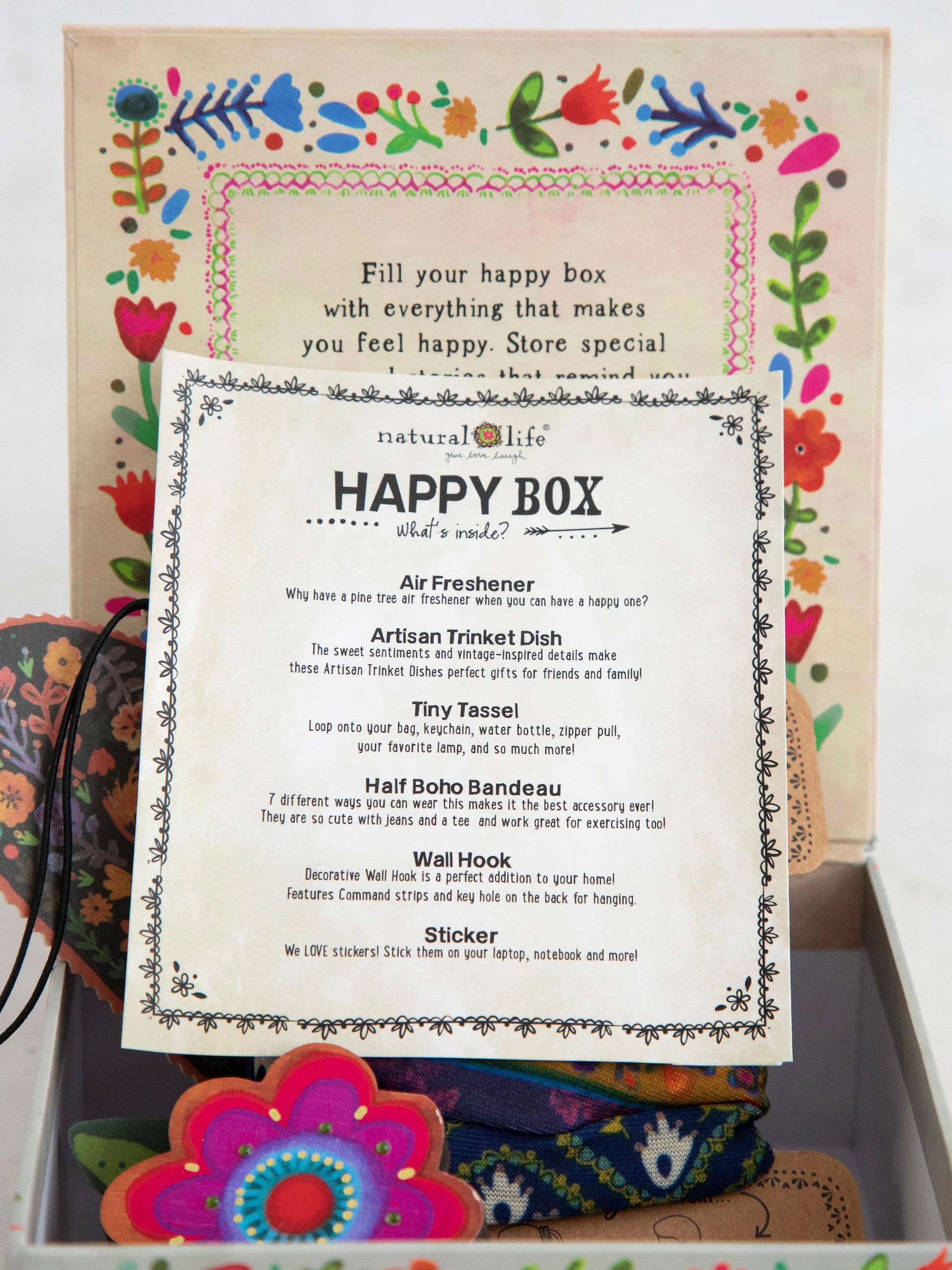 Happy Box packaging with colorful floral design and product list.