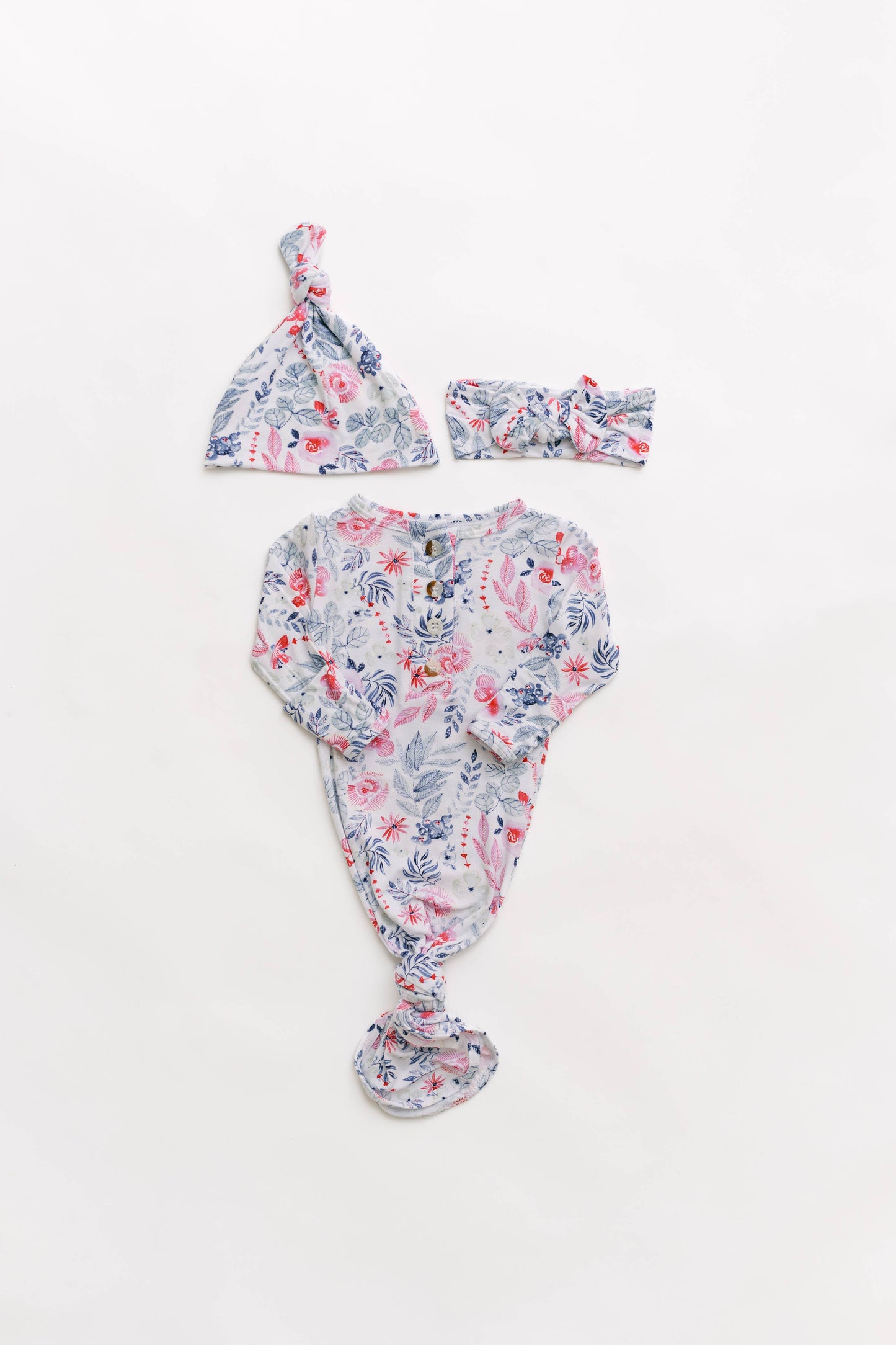 Floral baby outfit with hat and headband on a white background