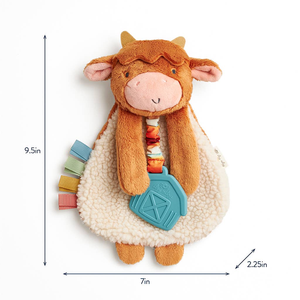 Plush cow toy with colorful elements and measurements on a white background