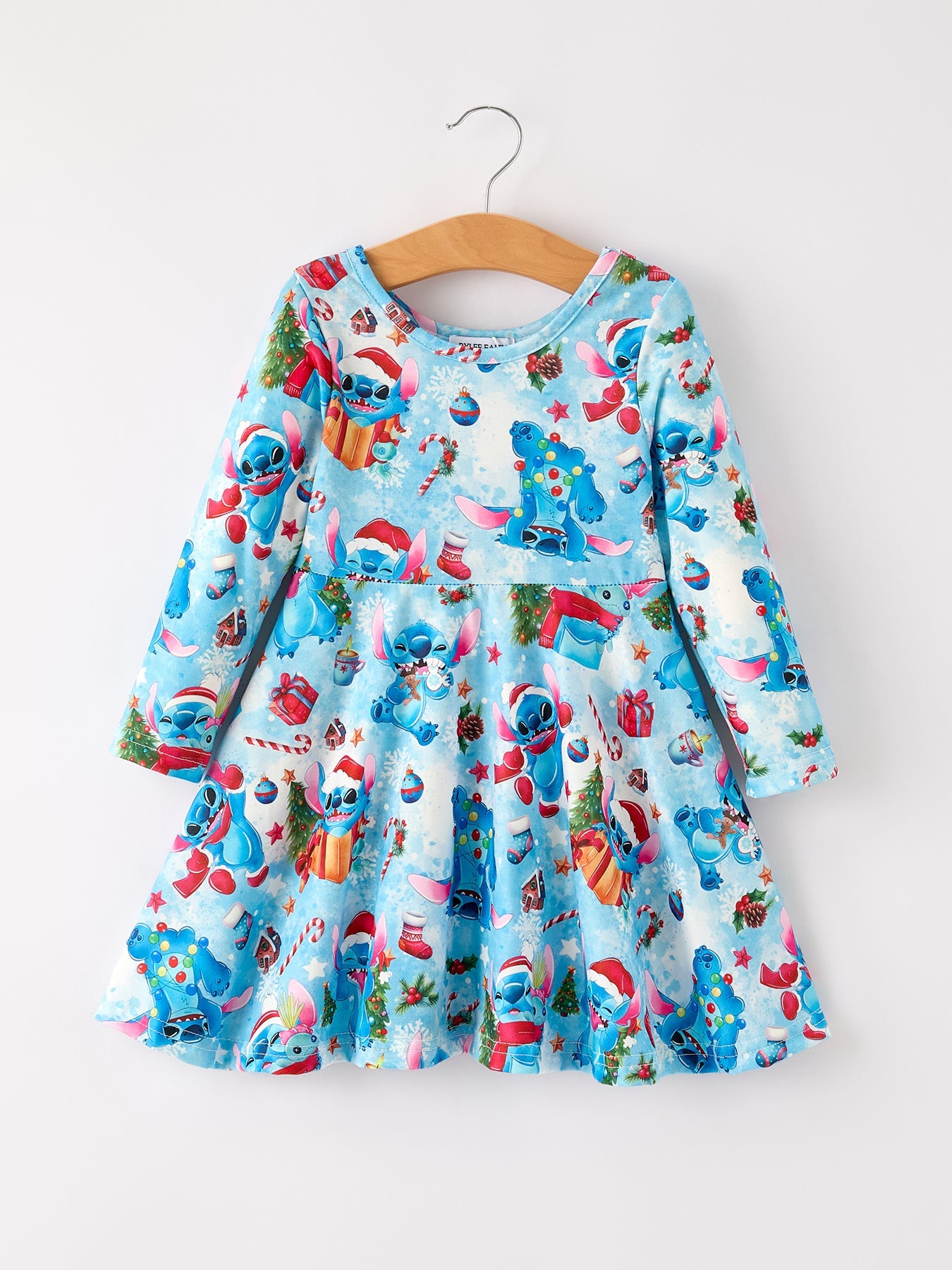Children's dress with cartoon character print on a hanger against a white background