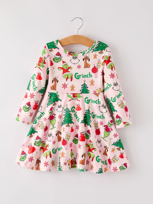 Children's dress with Grinch print on a hanger against a white background
