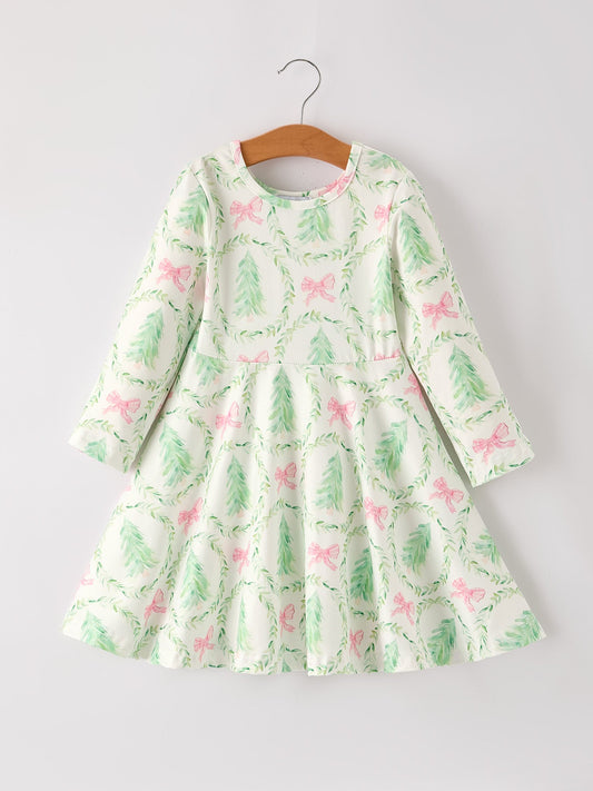 Green dress with pink floral pattern on a hanger against a white background