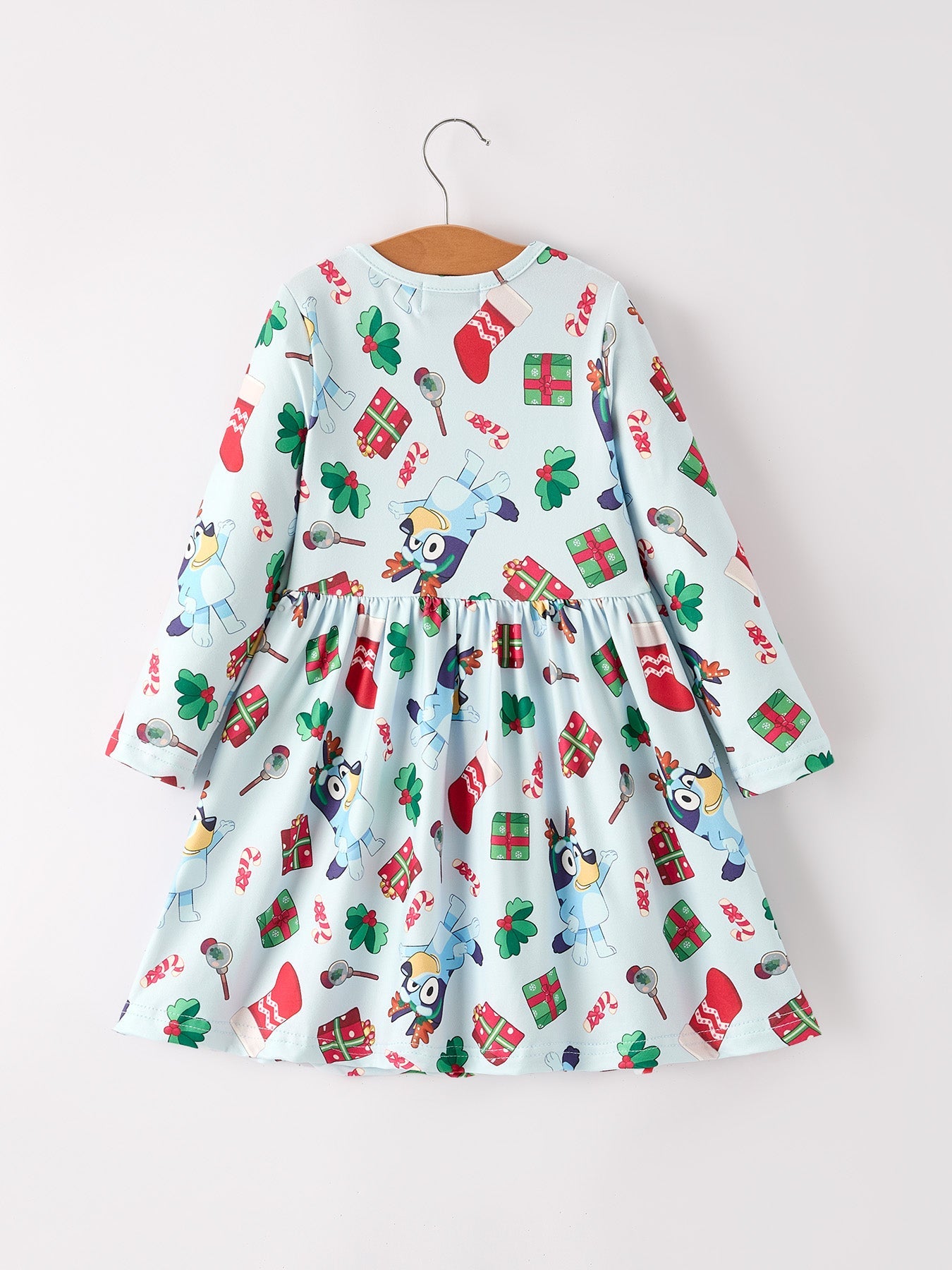 Children's dress with Christmas-themed pattern on a white background
