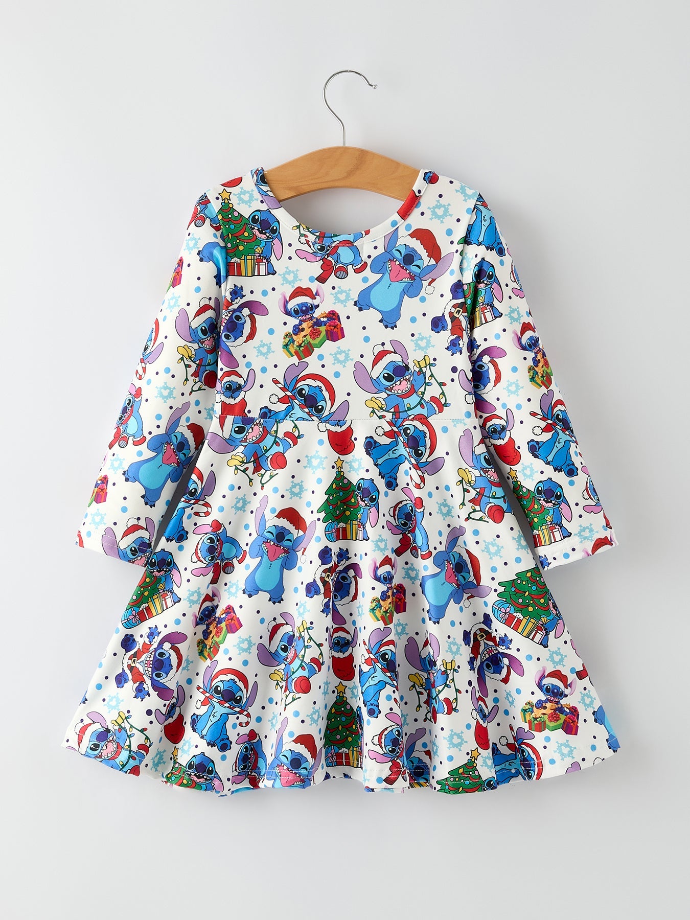 Children's dress with cartoon character print on a hanger against a white background