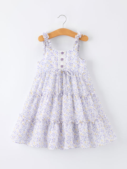 Floral dress on a wooden hanger against a white background