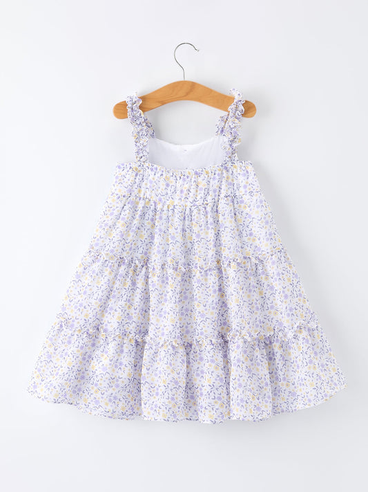 Floral dress on a wooden hanger against a white background