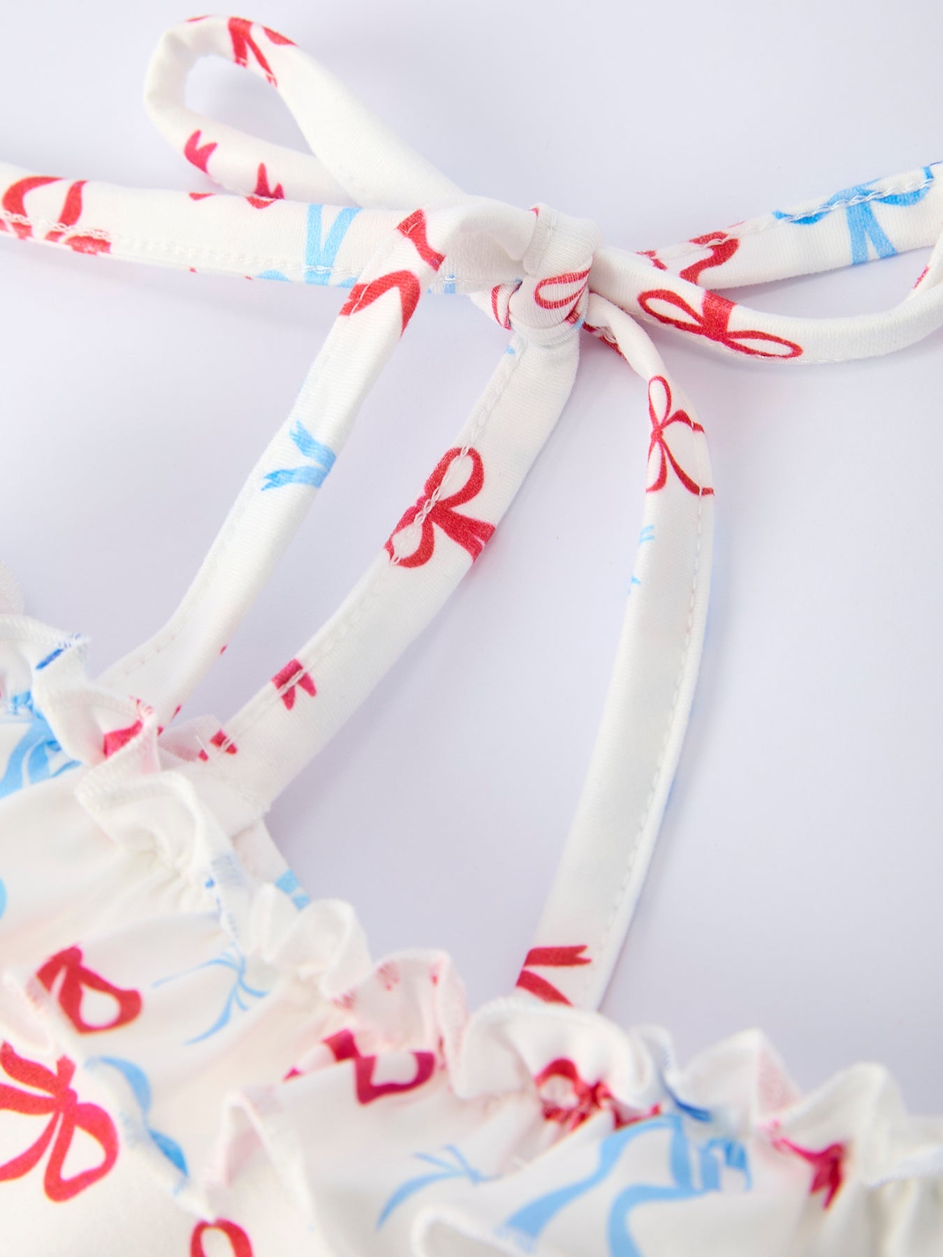 White dress with red and blue floral patterns on a white background