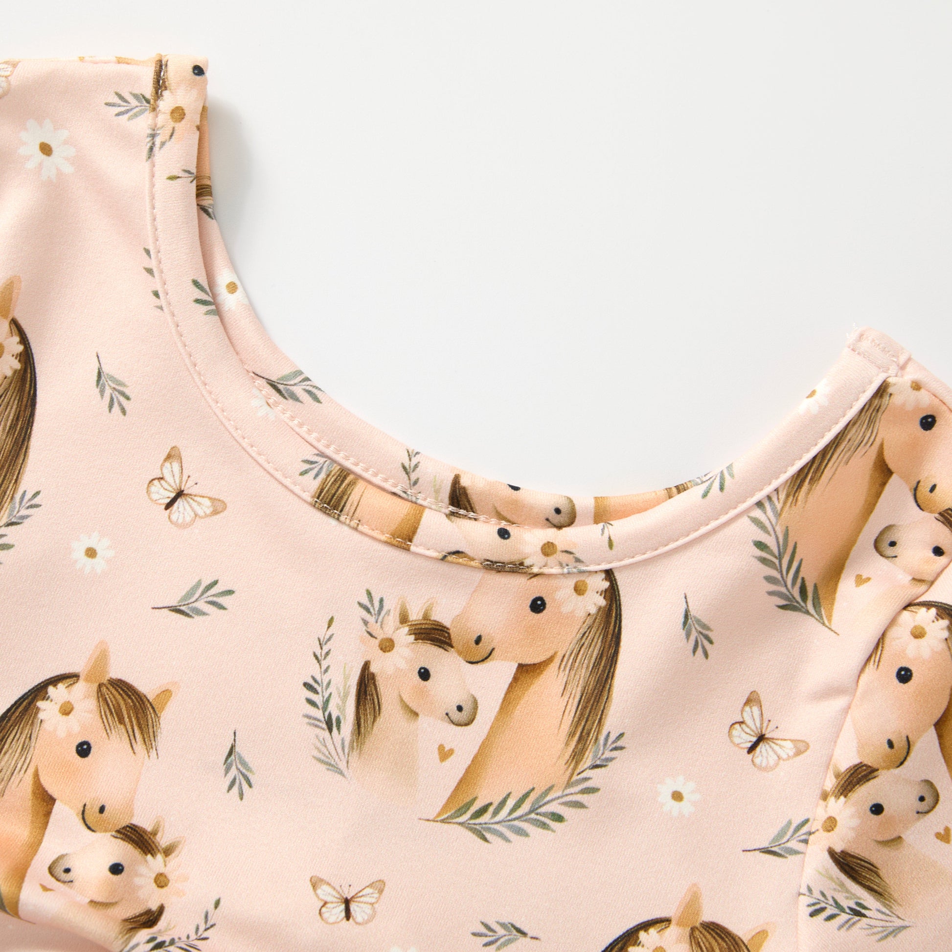 Top with horse and pattern on a light pink background