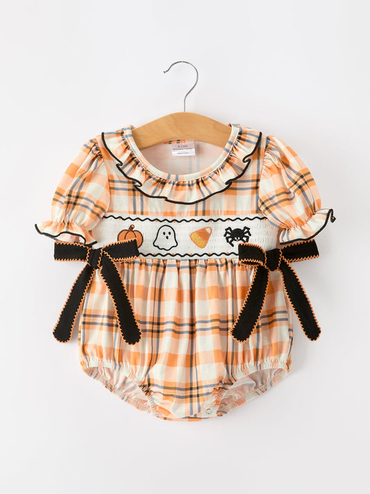 Baby romper with Halloween-themed design on a hanger against a white background