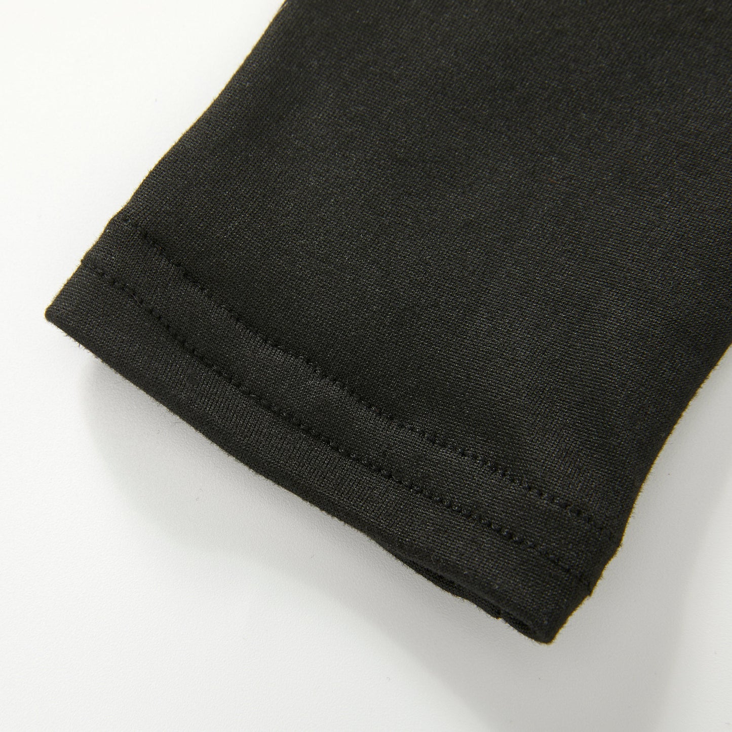 Close-up of the fabric cuff with a neat hemmed edge on a white background.