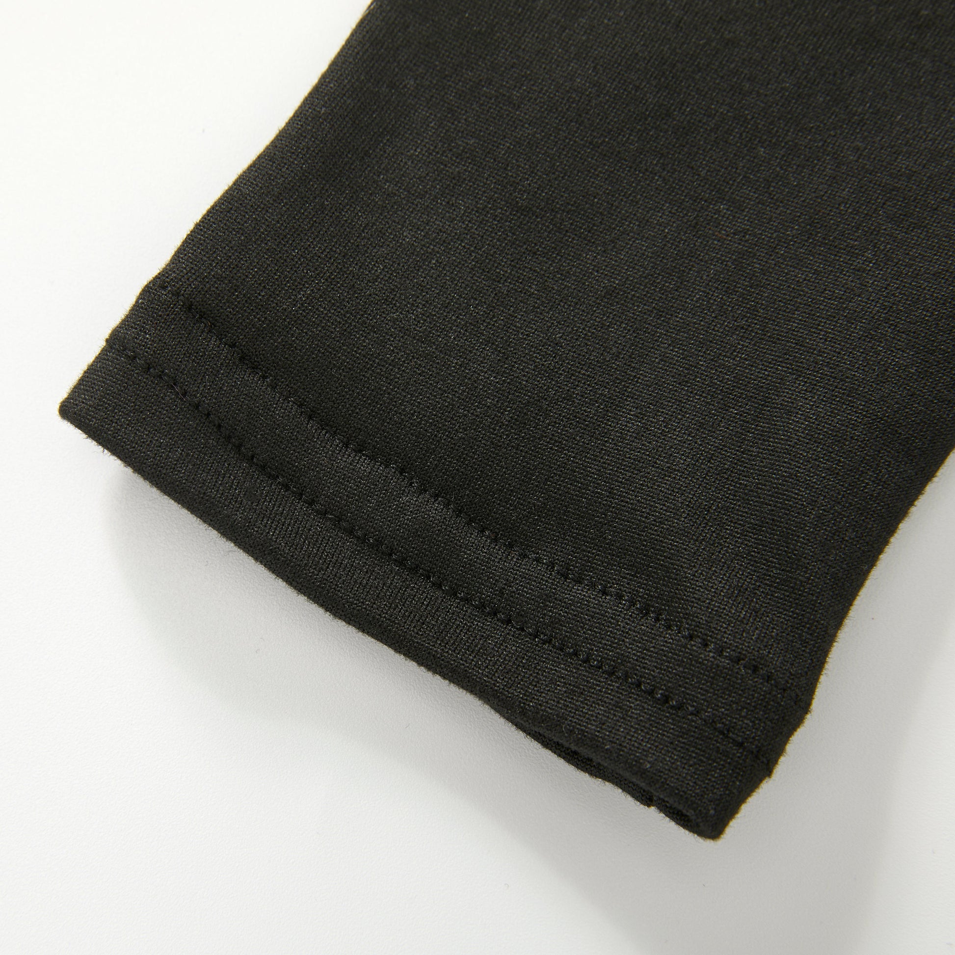 Close-up of the fabric cuff with a neat hemmed edge on a white background.