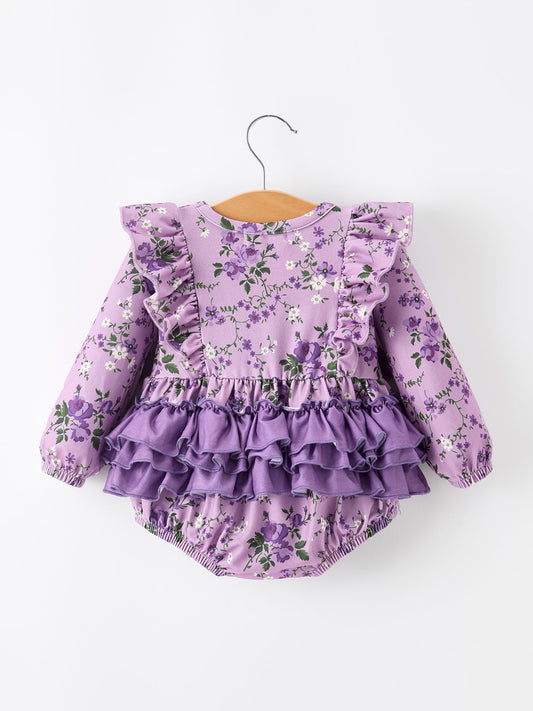 Purple floral baby outfit with ruffled details on a white background