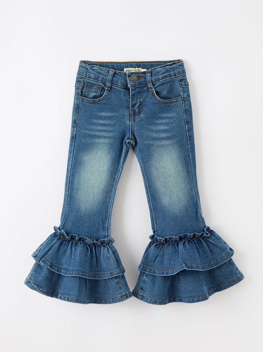 Blue jeans with ruffled cuffs on a white background