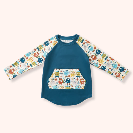 Children's long-sleeve shirt with a colorful & fun monster pattern on a white background