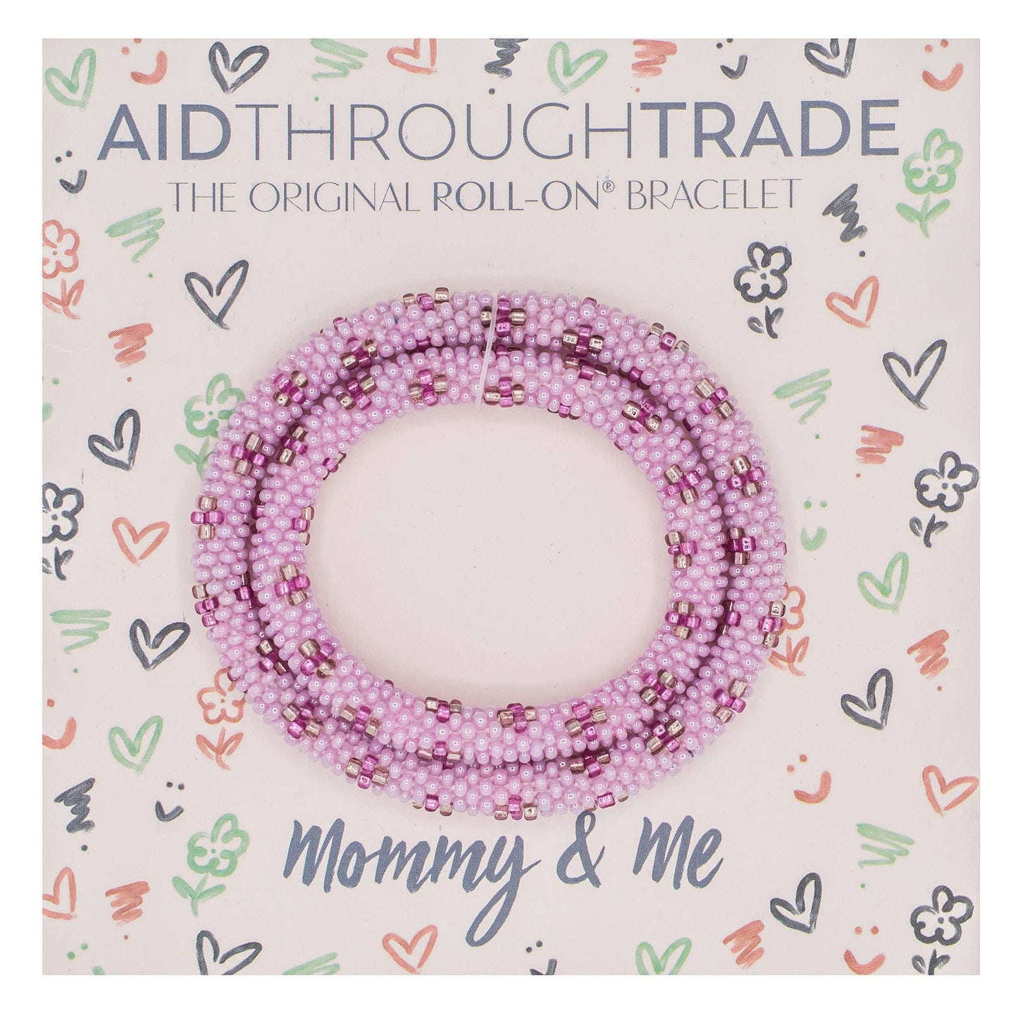 Pink beaded bracelet on Aid Through Trade packaging with decorative patterns