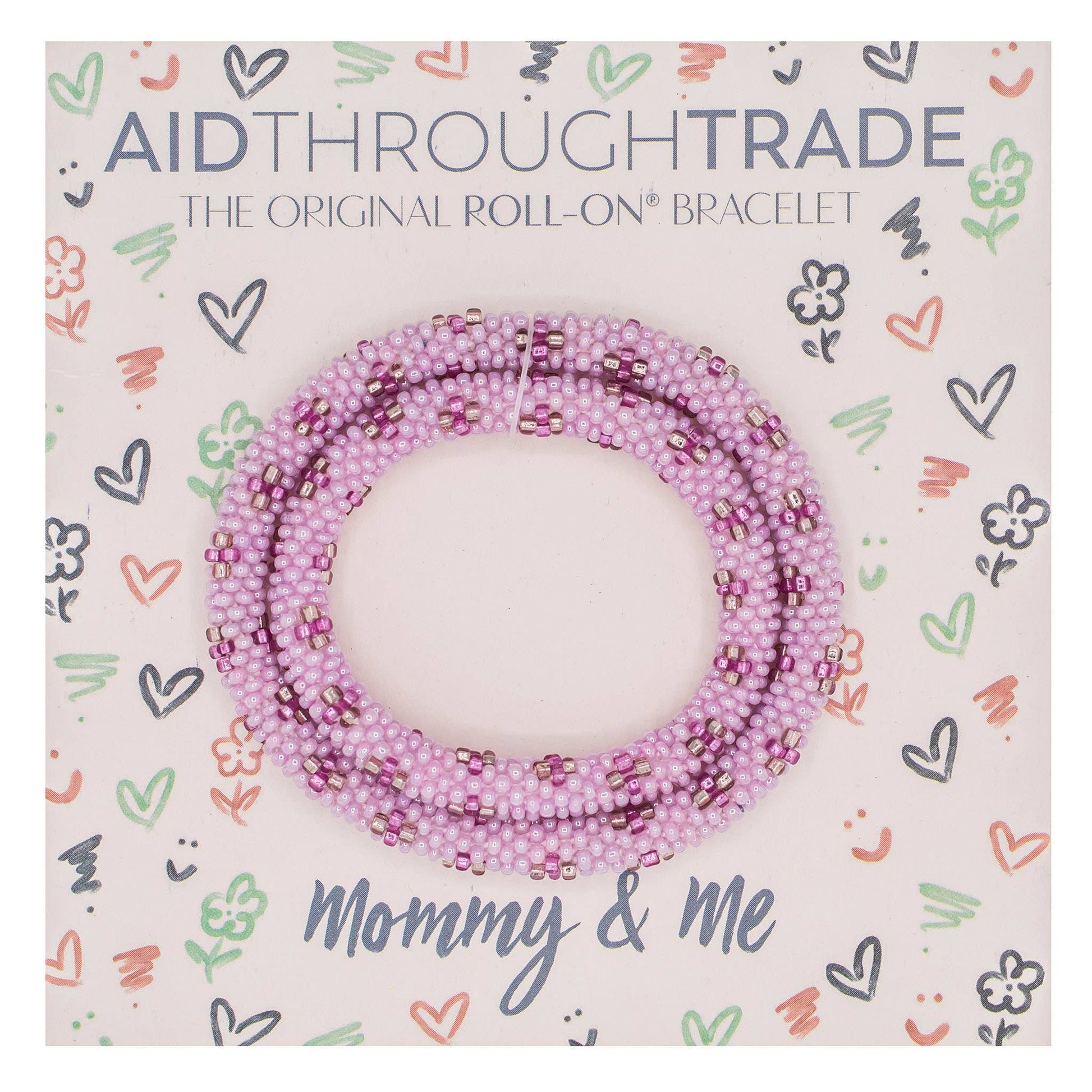 Pink beaded bracelet on Aid Through Trade packaging with decorative patterns
