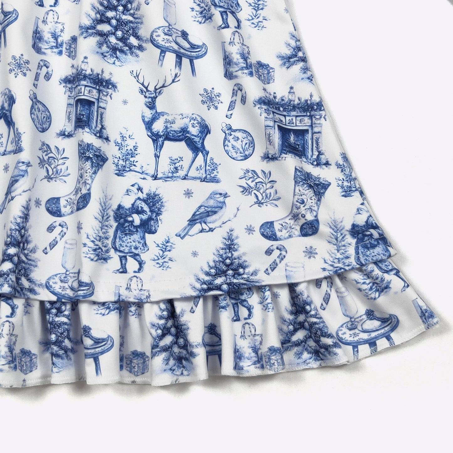 Blue and white Christmas-themed fabric with reindeer, trees, and stockings on a white background