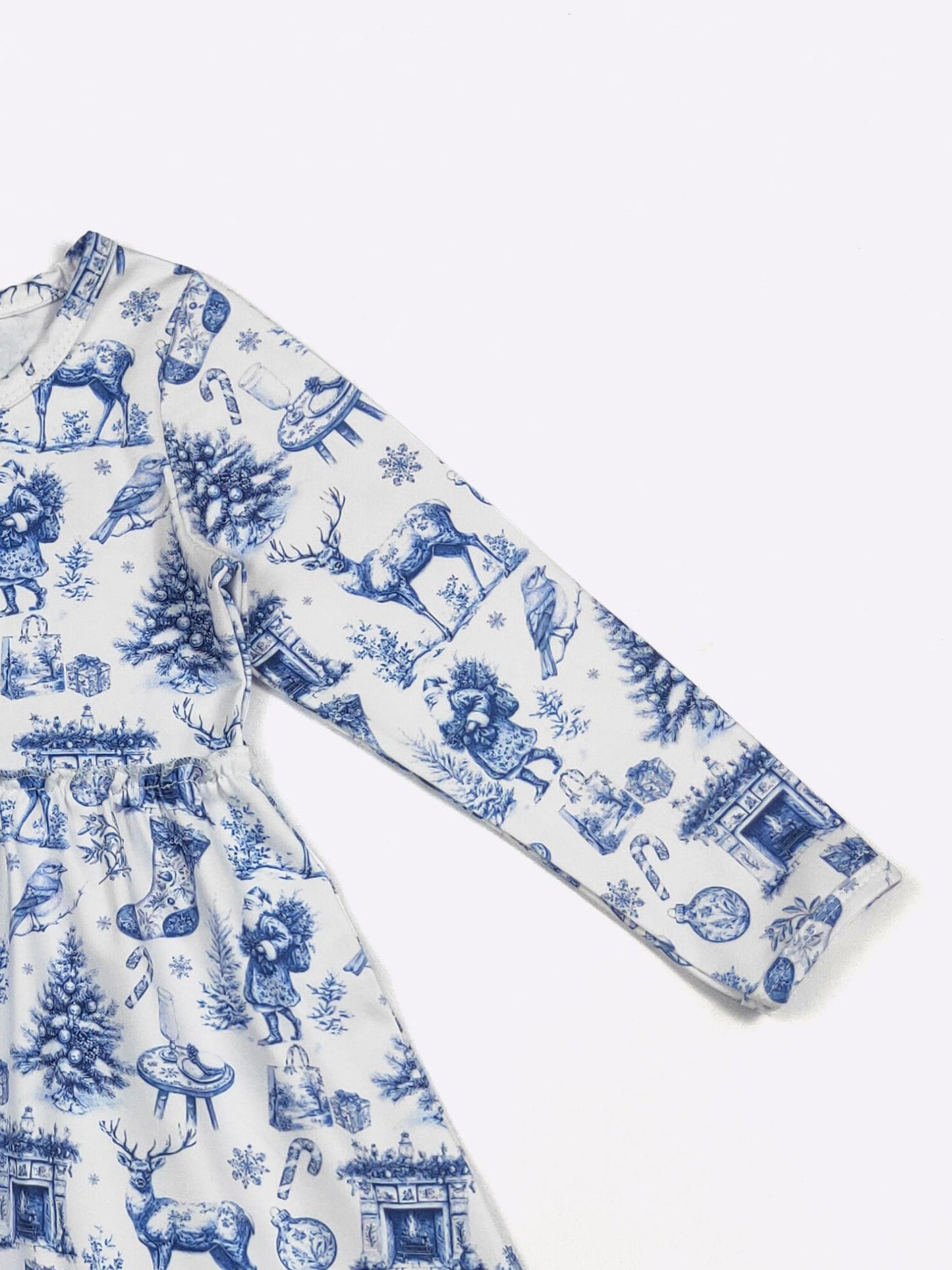 White pajama set with blue holiday-themed print on a white background