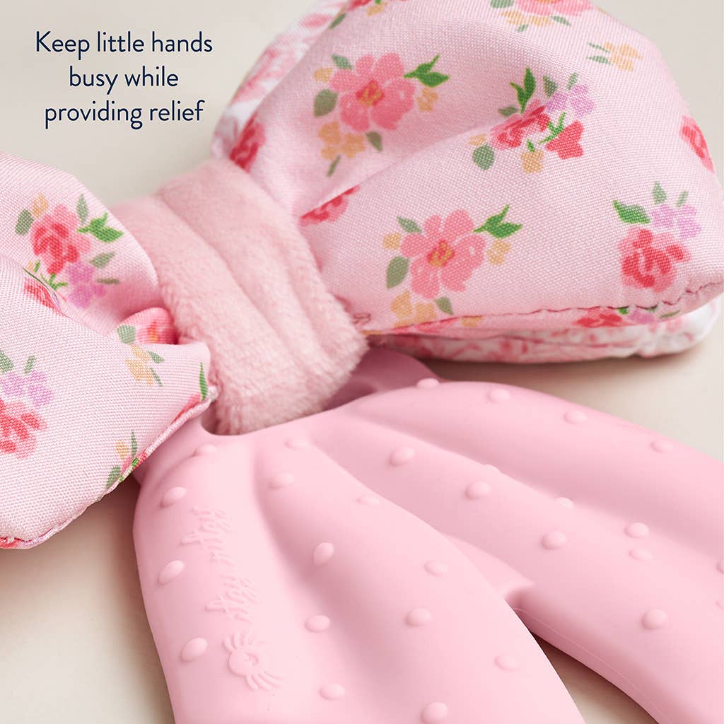 Pink baby products with floral pattern on a light background