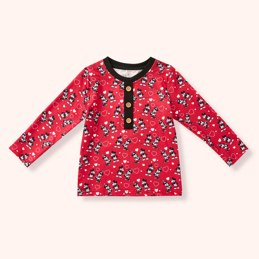 Red long-sleeve shirt with black and white pattern on a white background