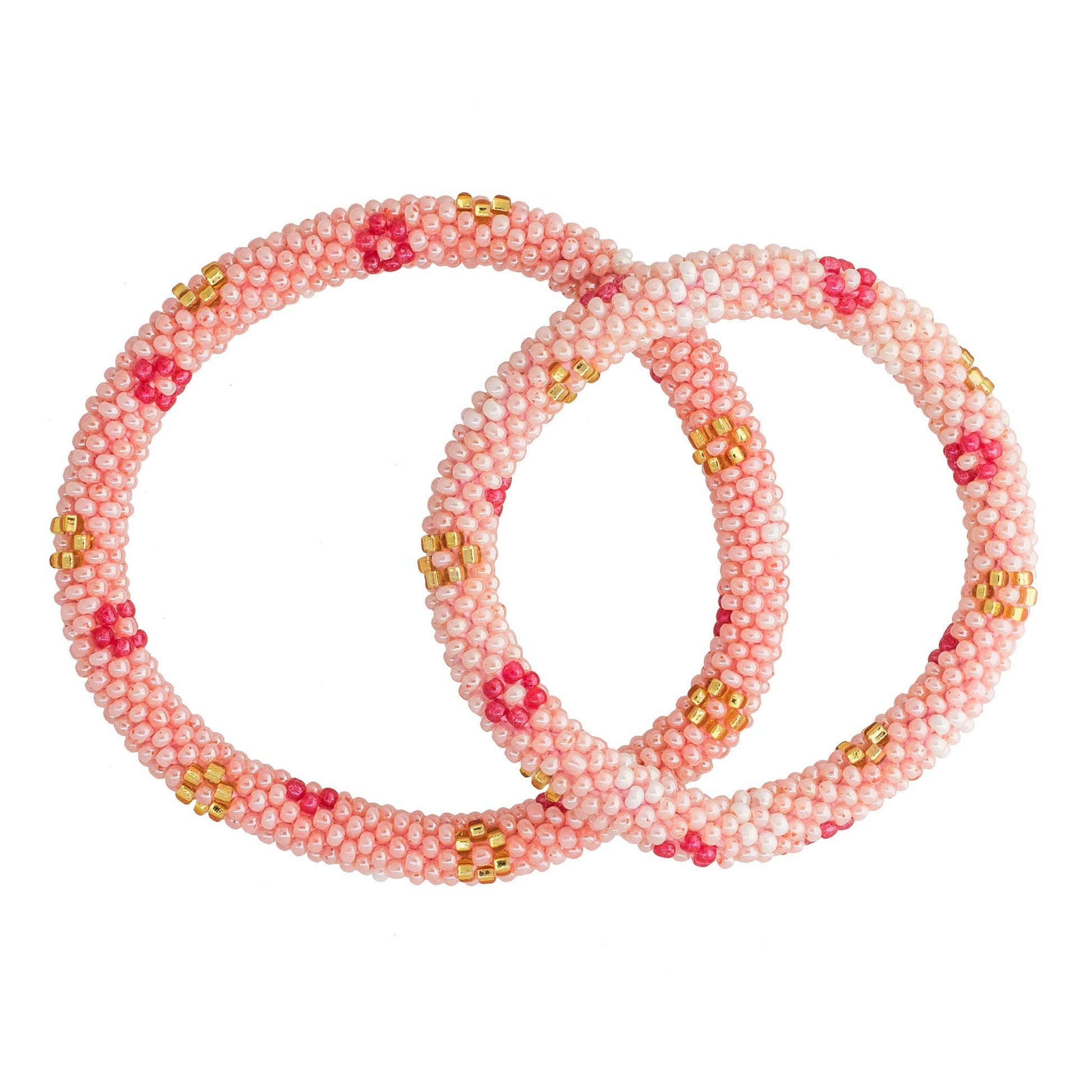 Set of pink beaded bracelets with gold accents on a white background