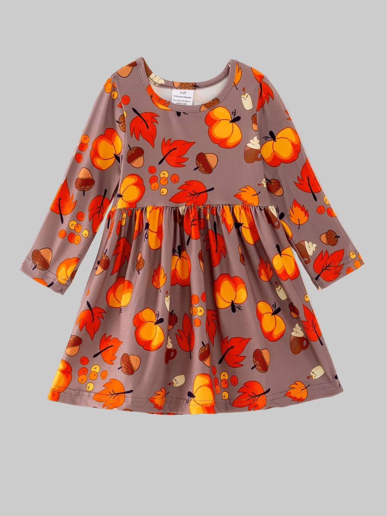 Fall themed dress with pumpkins, acorns & leaves against a light grey background