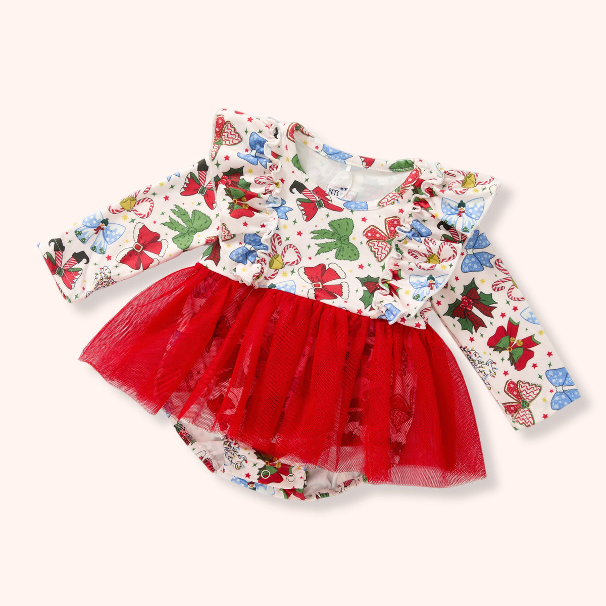 A baby girl's long-sleeve dress featuring a white top with a colorful Christmas-themed print of bows, candy canes, and Santa Claus, paired with a bright red tulle tutu skirt.