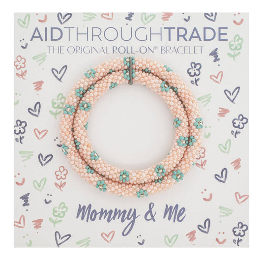 Packaging of 'Aid Through Trade' bracelet with floral design and text.