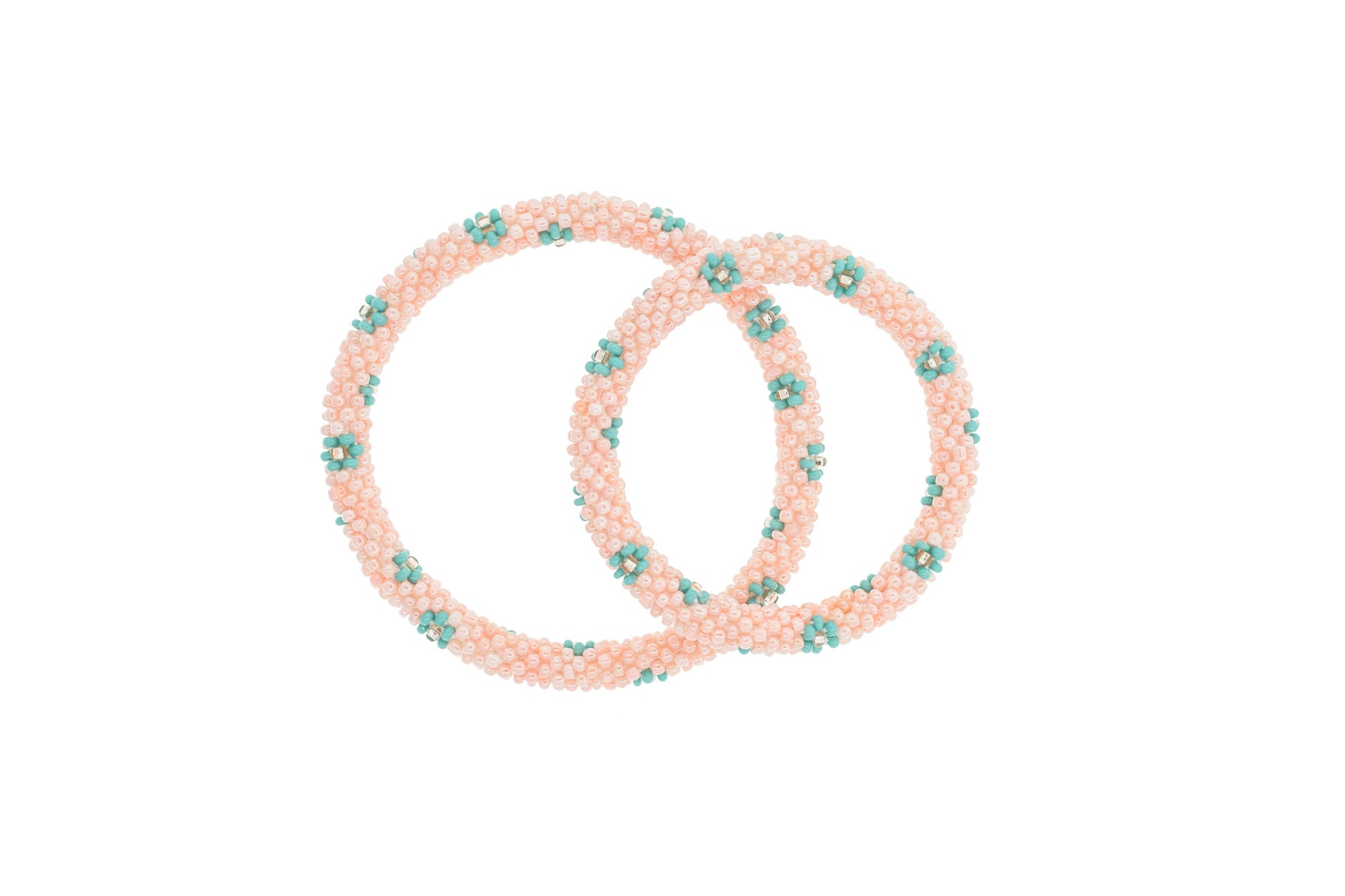 Set of pink hair ties with green floral designs on a white background