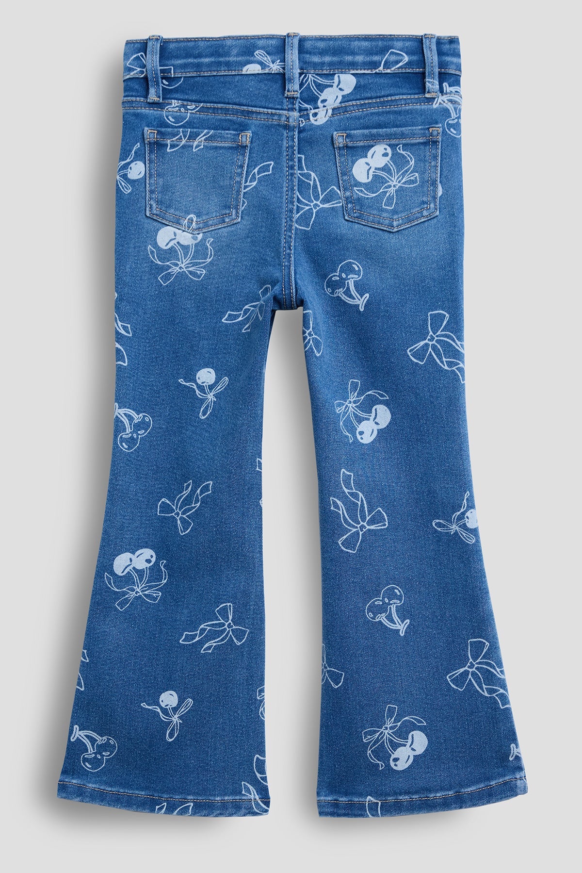 Blue jeans with white floral patterns on a light gray background