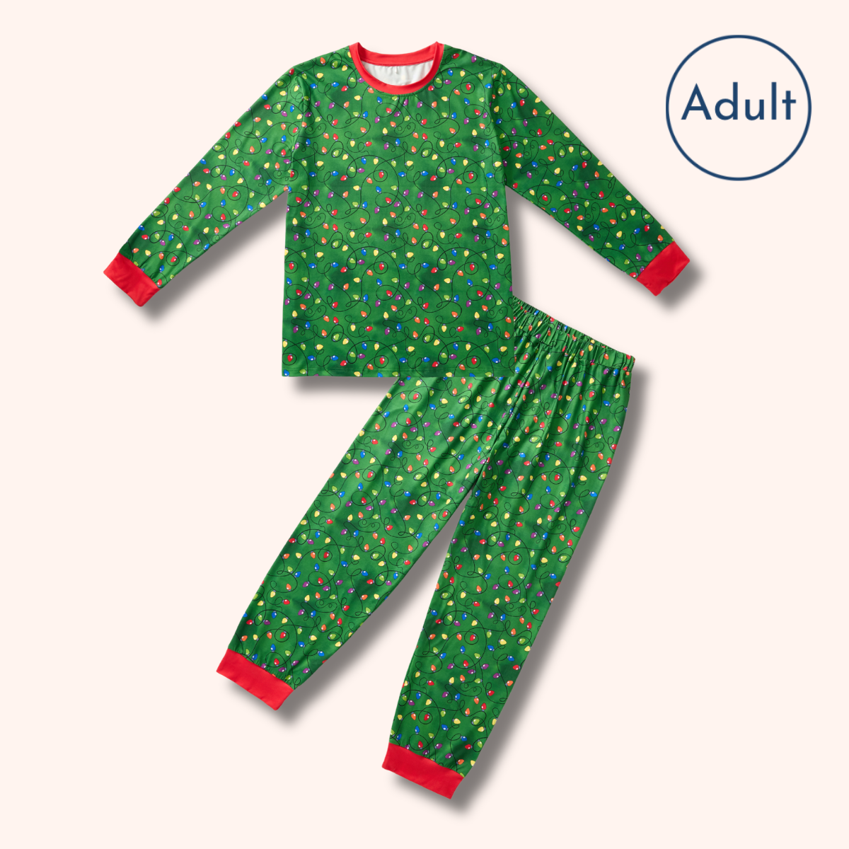 A two-piece adult pajama set featuring a long-sleeve top and matching pants in a green Christmas tree pattern with small colorful ornaments, finished with red cuffs and hem, shown on a light beige background with an 'Adult' label in the top right.
