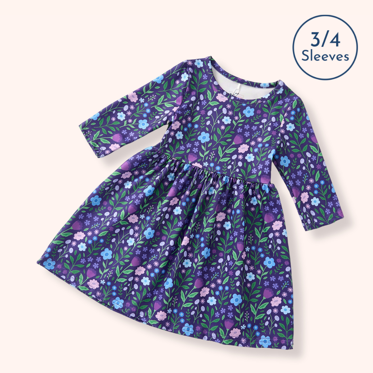 A girls' long-sleeve dress with a purple, blue, and pink floral print, shown on a light beige background with a '3/4 Sleeves' badge in the top right corner.