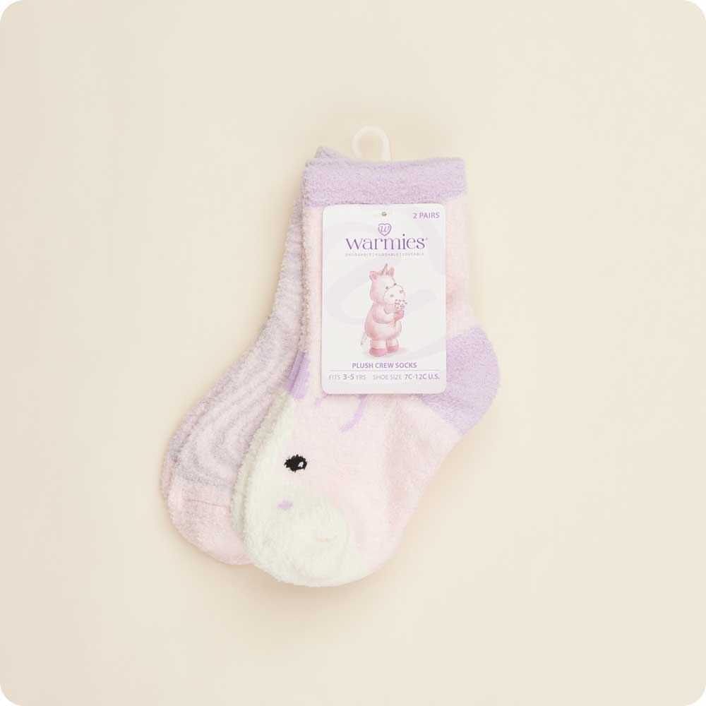 Pair of purple and white socks with a 'Warmies' label on a beige background
