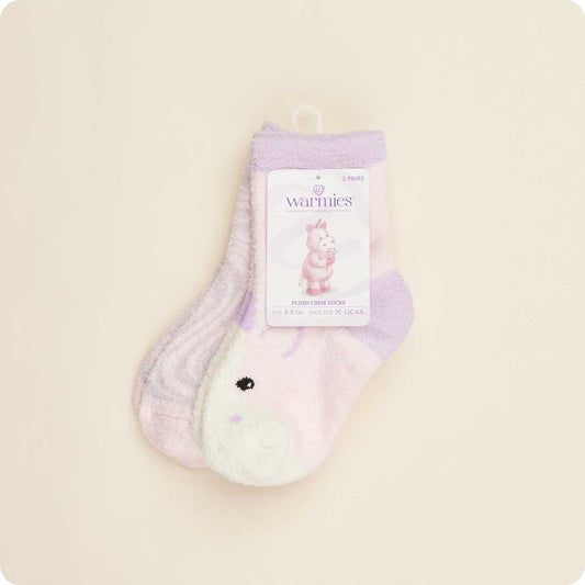 Pair of purple and white socks with a 'Warmies' label on a beige background