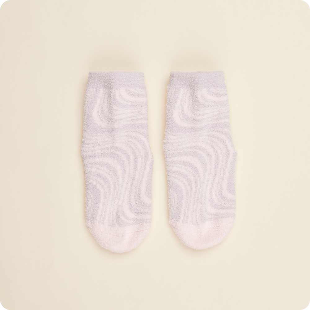 Pair of light purple socks with a subtle pattern on a beige background