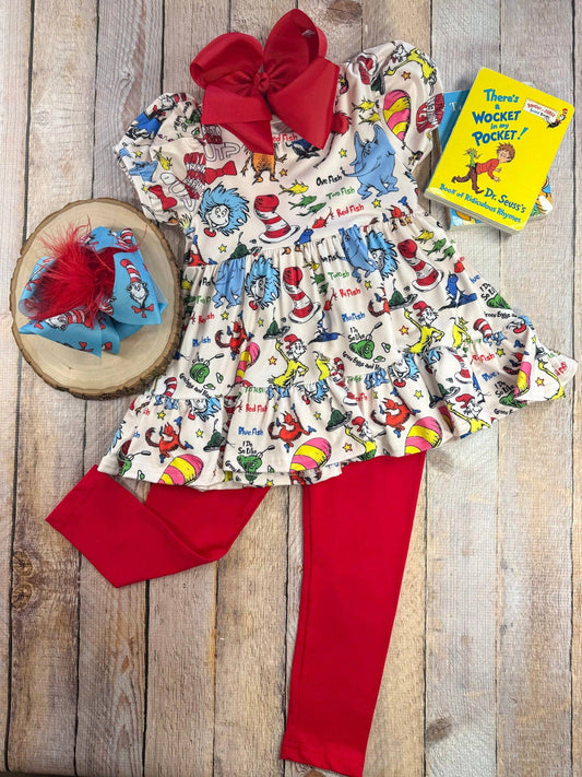 Children's outfit with Dr. Seuss-themed dress, red leggings, and matching headband on a wooden surface.