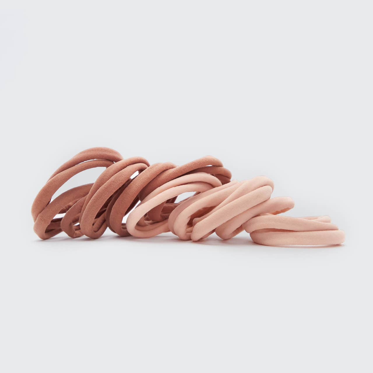 Set of pink hair ties on a light gray background