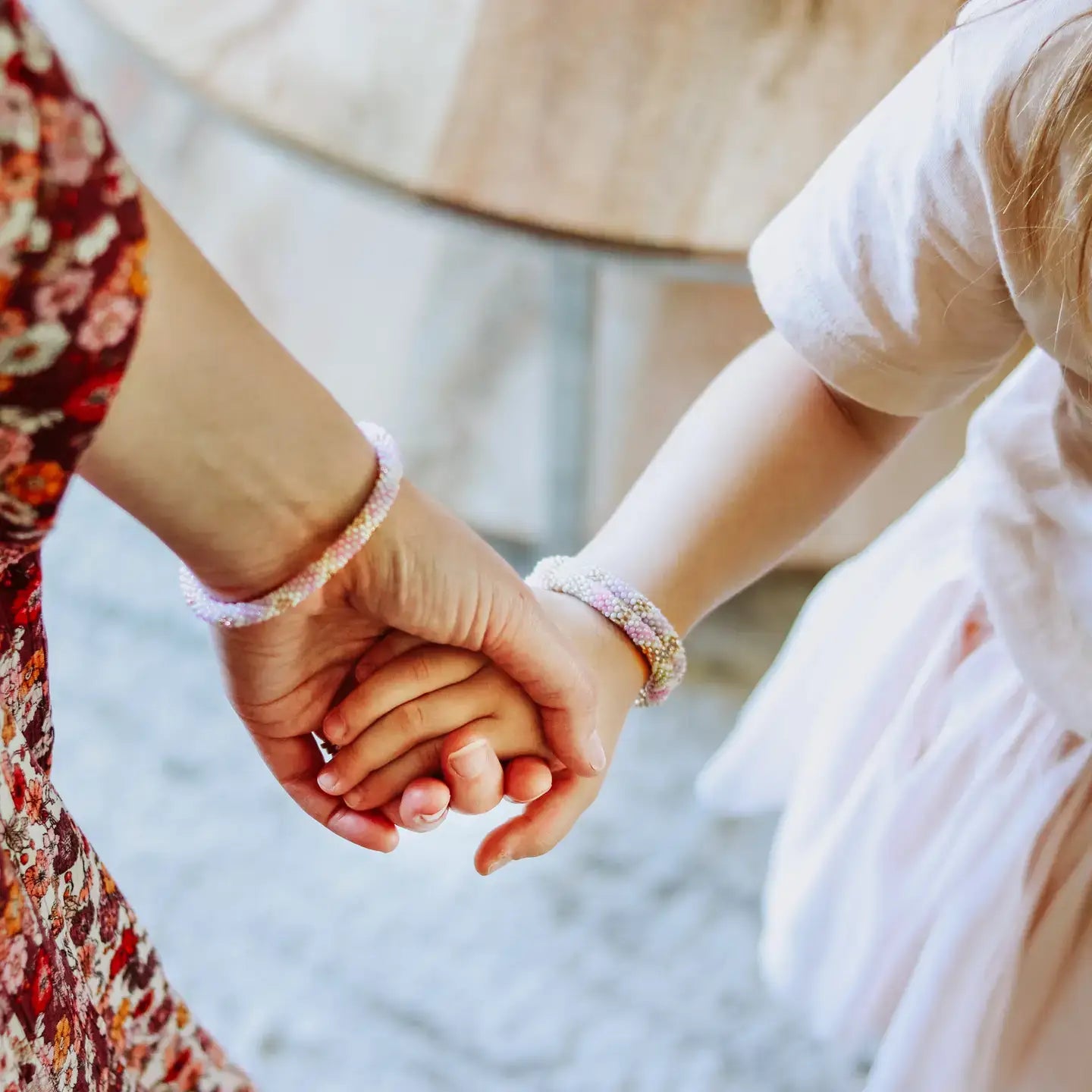 Two hands holding each other with a blurred background