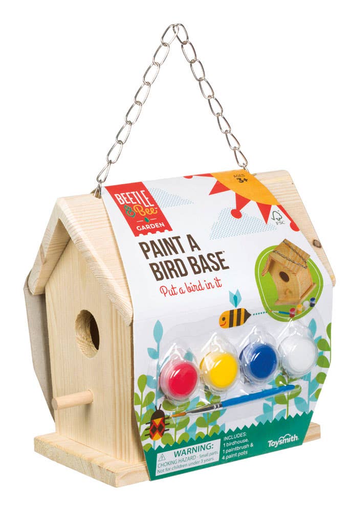 Wooden birdhouse with paint canisters and packaging labeled 'Paint a Bird Base' on a white background