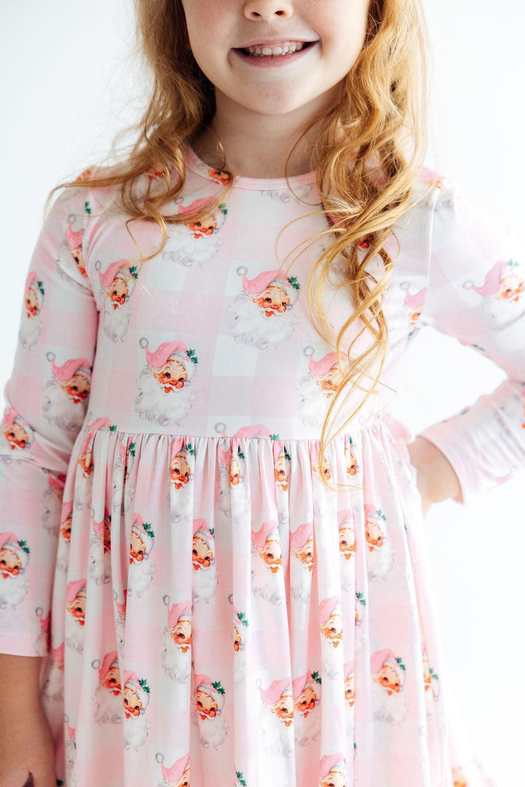 Young girl wearing a floral dress with a white background